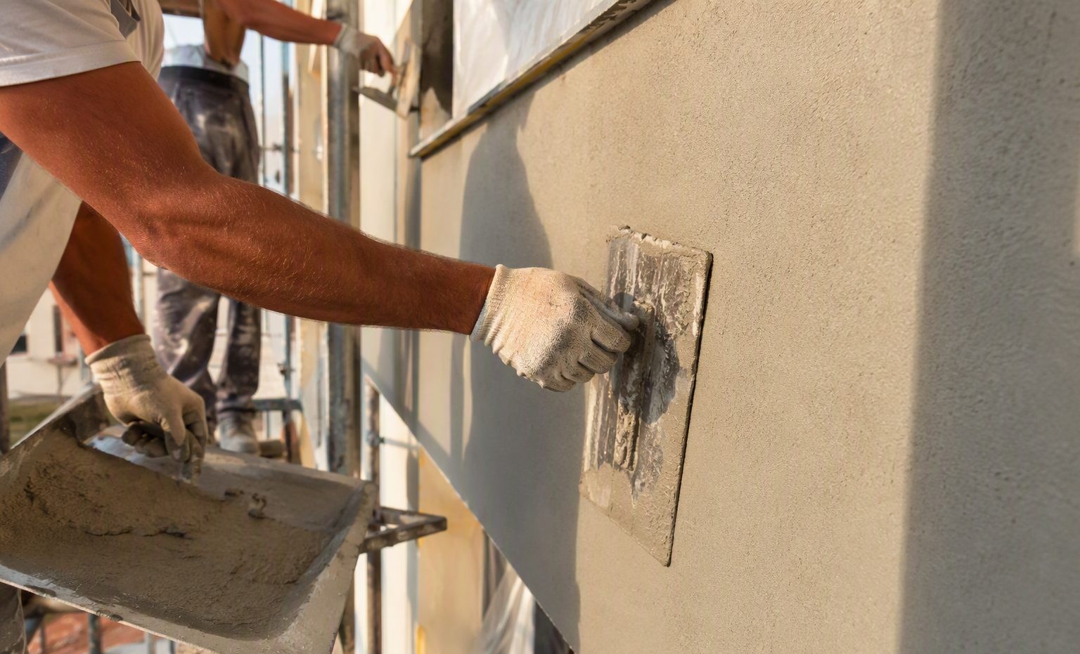 Crew applying a smooth finish stucco coat on a Pasco, WA home